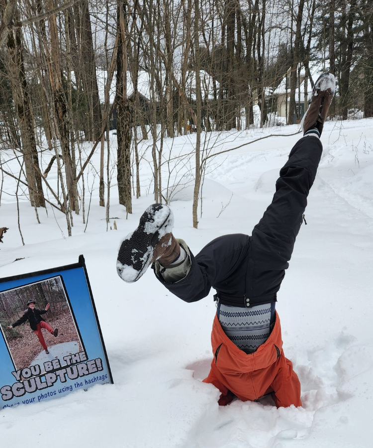 Person doing handstand in snow
